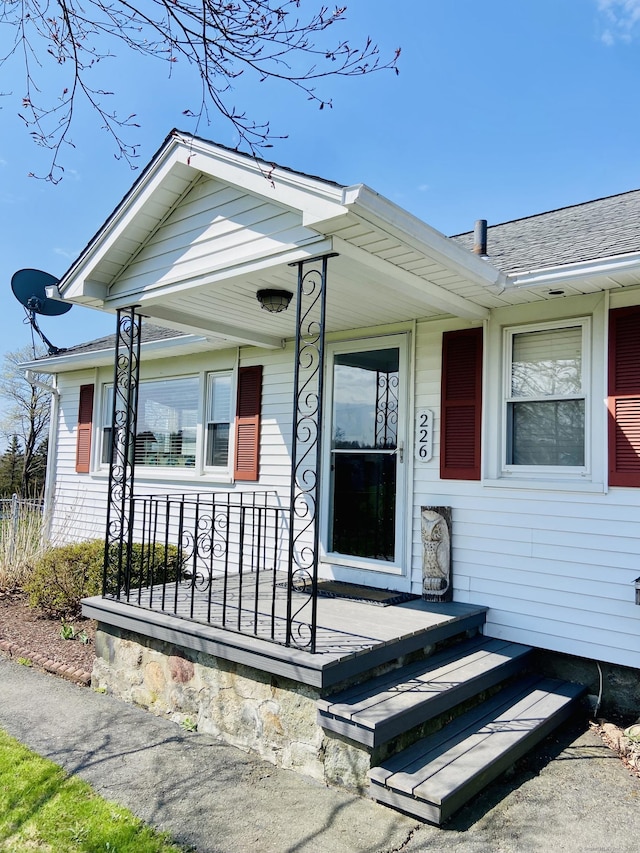 view of front facade featuring a porch and roof with shingles