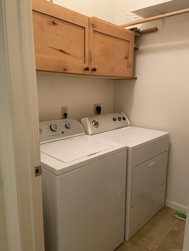 washroom with cabinet space and washing machine and clothes dryer