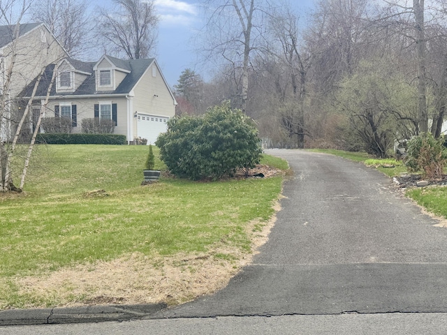 view of front facade with a front yard and driveway