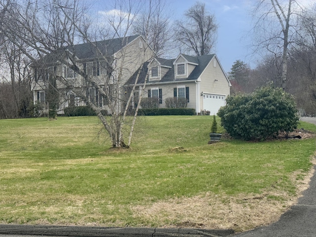 view of front of home featuring a garage and a front lawn