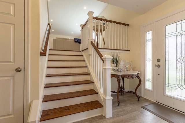 entryway featuring stairway, baseboards, wood finished floors, and recessed lighting