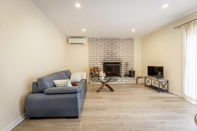 living room with a wall mounted air conditioner, recessed lighting, wood finished floors, and a fireplace