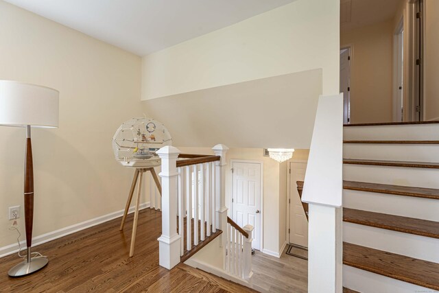 stairway featuring wood finished floors and baseboards