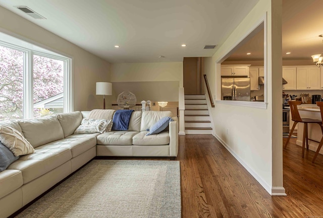 living room featuring visible vents, stairs, dark wood-style flooring, and recessed lighting