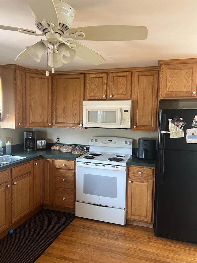 41 Hoffman Rd, Ellington, CT 06029 - kitchen with dark countertops, brown cabinetry, and white appliances