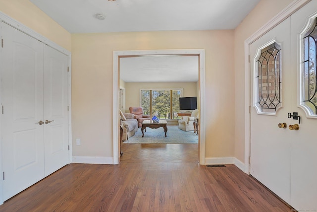 entryway featuring wood finished floors, visible vents, and baseboards