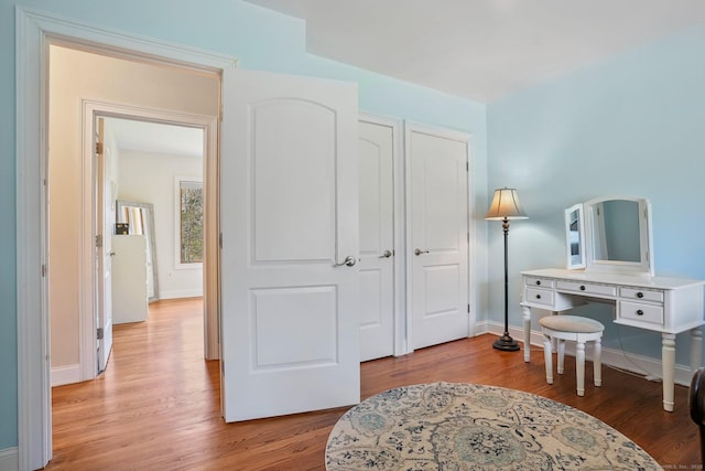 bedroom featuring baseboards and light wood-style floors