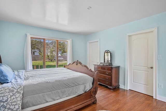 bedroom featuring wood finished floors and baseboards