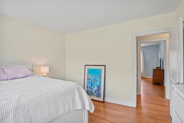 bedroom with baseboards and light wood-type flooring