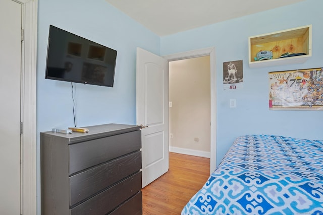 bedroom with baseboards and light wood-style flooring
