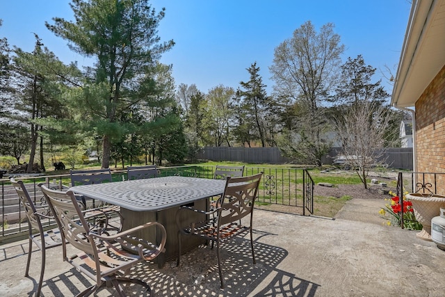 view of patio with fence and outdoor dining area
