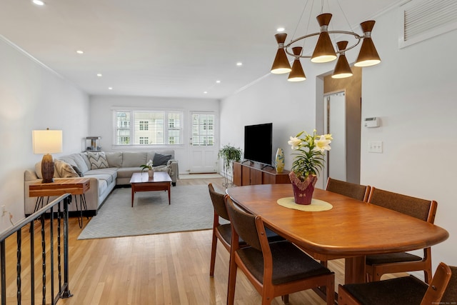 dining space featuring ornamental molding, recessed lighting, light wood-style flooring, and visible vents
