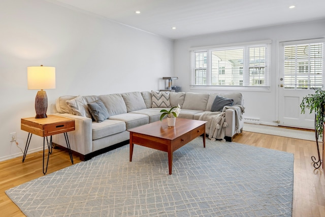 living area with recessed lighting, baseboards, and light wood finished floors