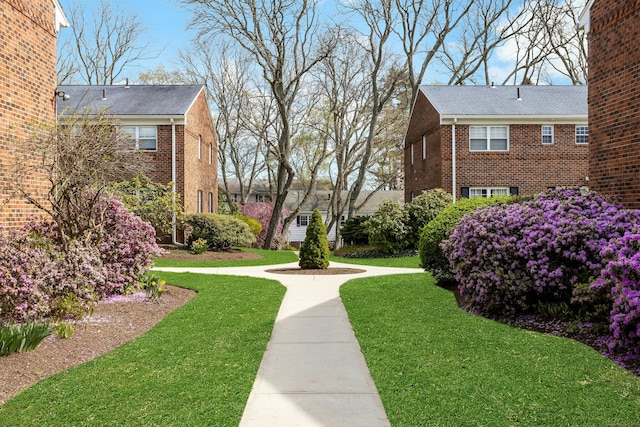 view of property's community with a yard