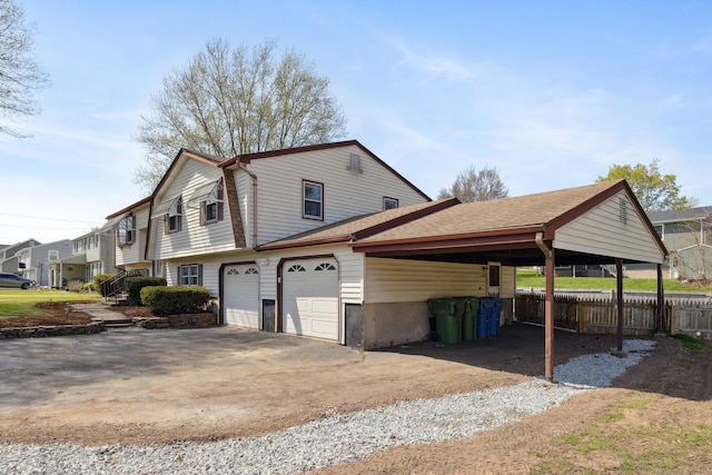 view of home's exterior with a shingled roof, fence, a residential view, and driveway