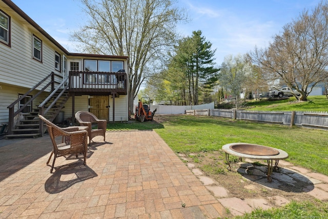 view of patio / terrace featuring a fenced backyard, stairs, and a deck