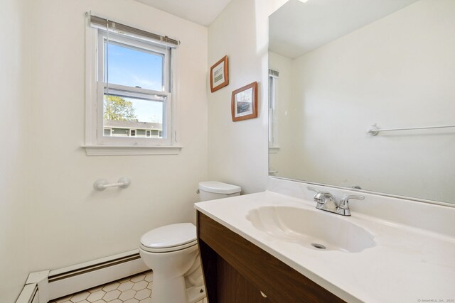 bathroom with vanity, a baseboard heating unit, and toilet