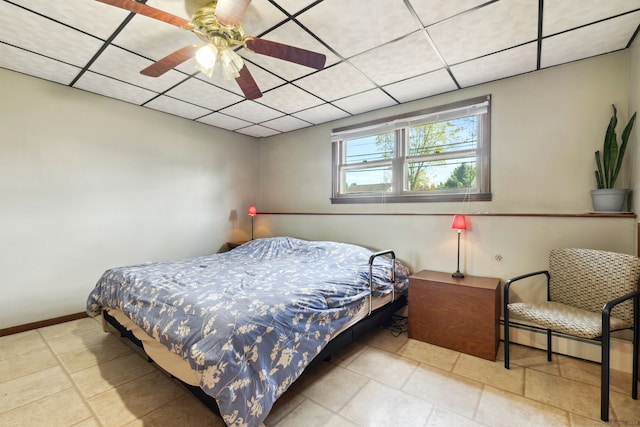 bedroom featuring baseboards, a baseboard radiator, ceiling fan, and a paneled ceiling