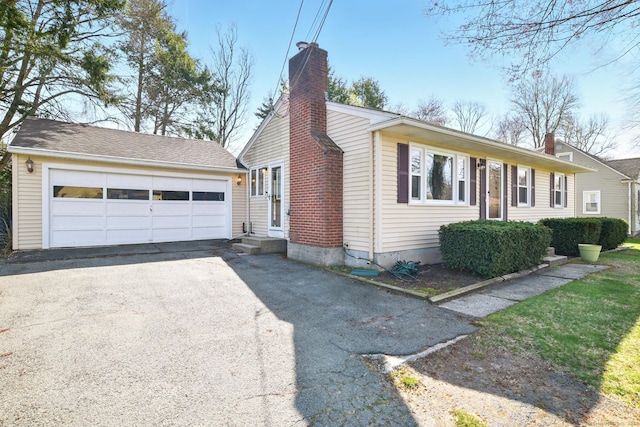94 Maple Ridge Dr, Somers, CT 06071 - view of side of property with a chimney, a detached garage, and entry steps