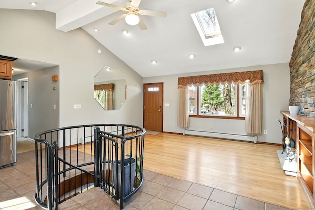 94 Maple Ridge Dr, Somers, CT 06071 - foyer entrance featuring a ceiling fan, light tile patterned floors, beamed ceiling, a skylight, and a baseboard radiator