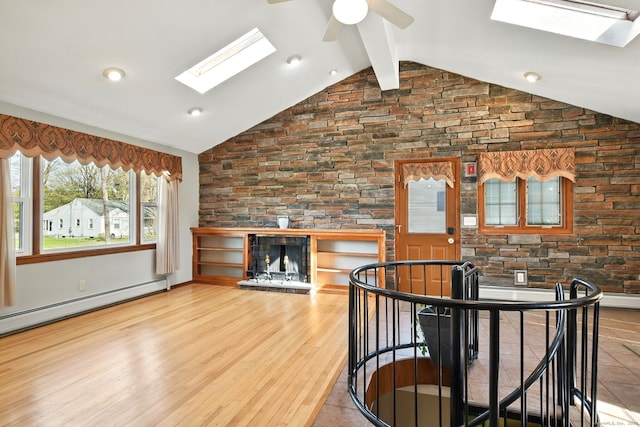 94 Maple Ridge Dr, Somers, CT 06071 - interior space with high vaulted ceiling, baseboard heating, wood finished floors, a skylight, and ceiling fan