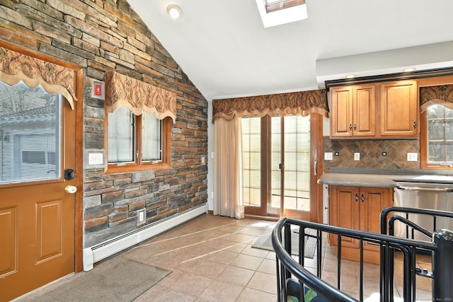 94 Maple Ridge Dr, Somers, CT 06071 - kitchen featuring a baseboard heating unit, brown cabinetry, backsplash, and lofted ceiling with skylight