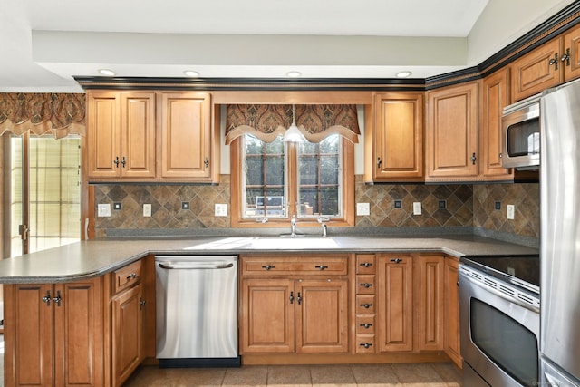 94 Maple Ridge Dr, Somers, CT 06071 - kitchen featuring tasteful backsplash, a sink, brown cabinetry, a peninsula, and appliances with stainless steel finishes