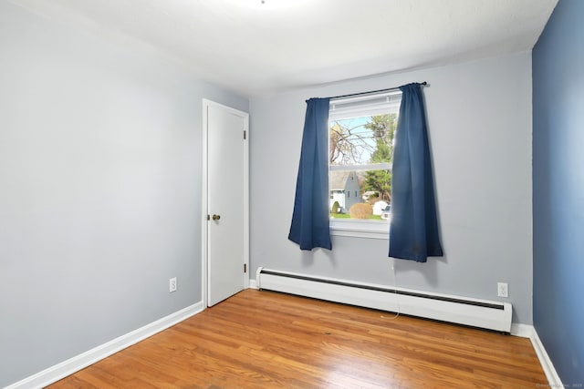94 Maple Ridge Dr, Somers, CT 06071 - spare room featuring a baseboard heating unit, wood finished floors, and baseboards