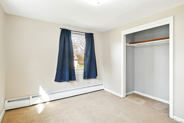 94 Maple Ridge Dr, Somers, CT 06071 - unfurnished bedroom with a baseboard radiator, baseboards, carpet flooring, and a closet