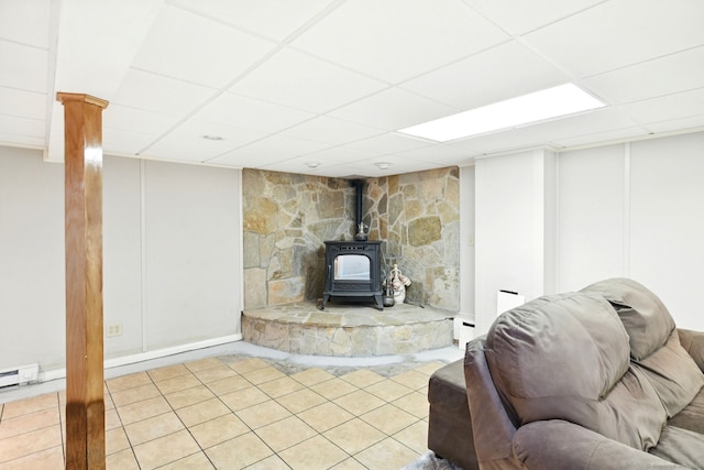 94 Maple Ridge Dr, Somers, CT 06071 - living area with tile patterned flooring, baseboard heating, a wood stove, and a paneled ceiling