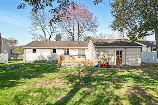 94 Maple Ridge Dr, Somers, CT 06071 - back of property featuring a lawn, fence, and a deck