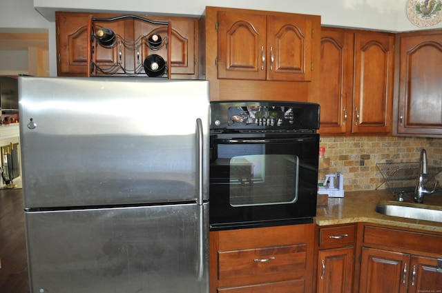 1 E Hayestown Rd Unit 142, Danbury, CT 06811 - kitchen featuring brown cabinetry, freestanding refrigerator, oven, a sink, and backsplash
