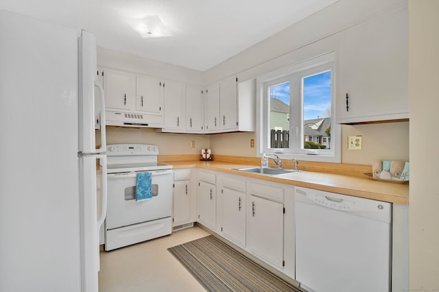 kitchen featuring a sink, under cabinet range hood, white appliances, and light countertops