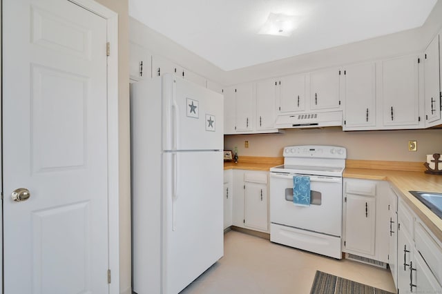 kitchen with light countertops, white cabinets, under cabinet range hood, and white appliances