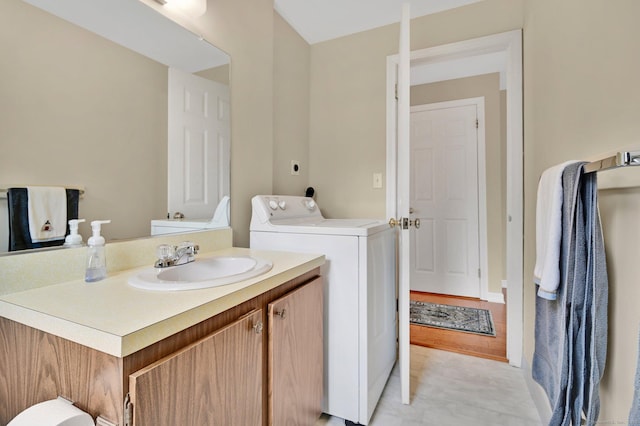 bathroom featuring washer / dryer and vanity