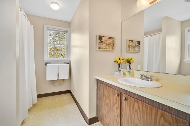 full bathroom with baseboards, tile patterned floors, and vanity