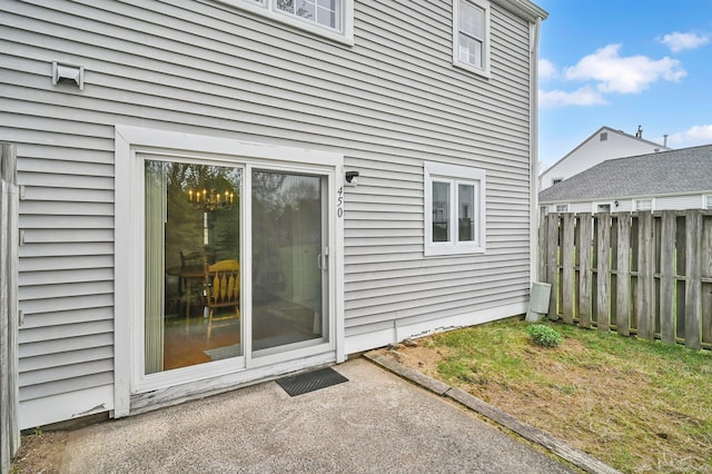 rear view of house featuring fence