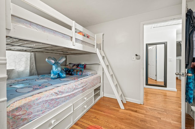 bedroom with baseboards and light wood-type flooring