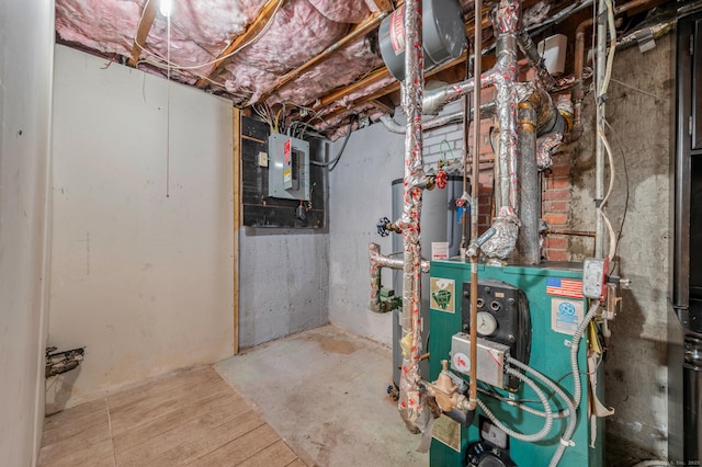 unfinished below grade area with a heating unit and electric panel