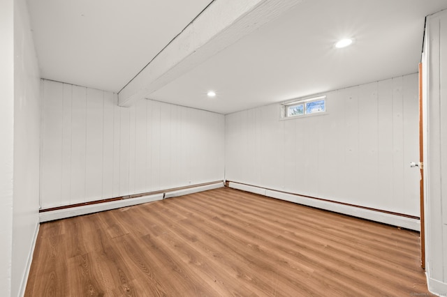 basement with baseboard heating and wood finished floors