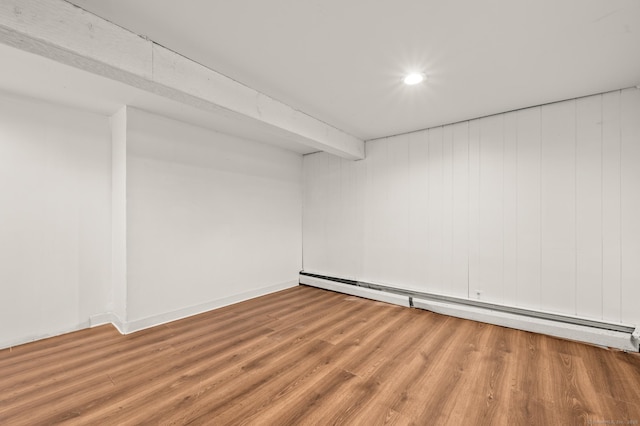 finished basement featuring recessed lighting, wood finished floors, and baseboard heating