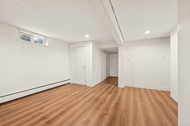 below grade area with recessed lighting, light wood-style floors, baseboards, and a baseboard radiator