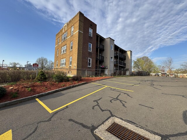 913 Wethersfield Ave, Hartford, CT 06114 - view of property featuring fence and uncovered parking