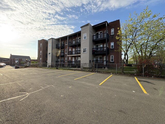 913 Wethersfield Ave, Hartford, CT 06114 - view of apartment building / complex with uncovered parking and fence