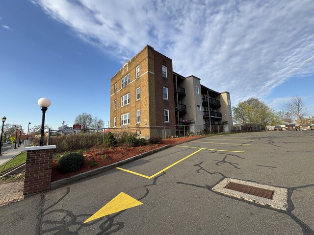 913 Wethersfield Ave, Hartford, CT 06114 - view of property featuring uncovered parking and fence