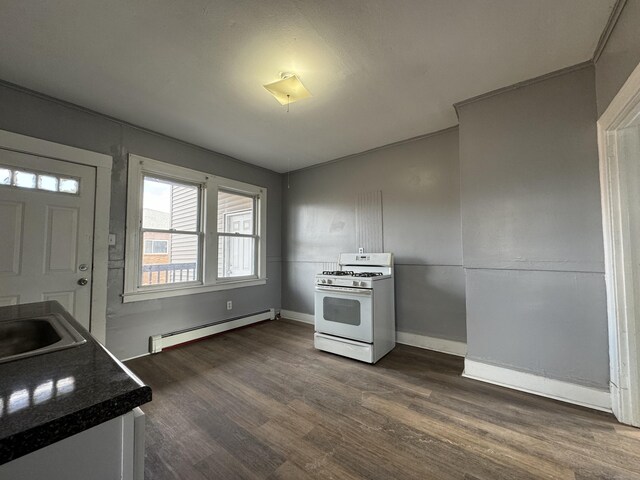 913 Wethersfield Ave, Hartford, CT 06114 - kitchen with white range with gas stovetop, a baseboard heating unit, dark wood-style flooring, a sink, and dark countertops