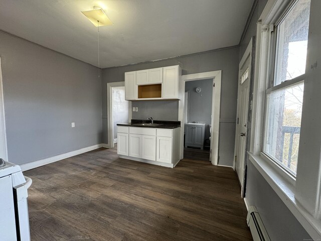 913 Wethersfield Ave, Hartford, CT 06114 - kitchen featuring white range, a sink, white cabinetry, dark countertops, and dark wood-style floors
