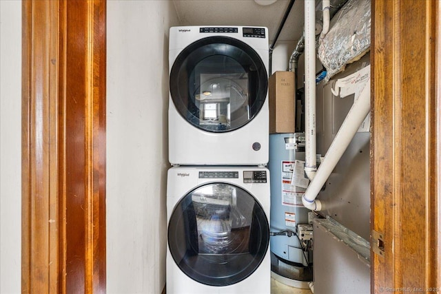 laundry area featuring stacked washing maching and dryer, gas water heater, and laundry area