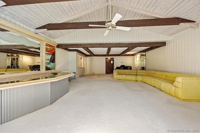 unfurnished living room with carpet floors, vaulted ceiling with beams, and ceiling fan