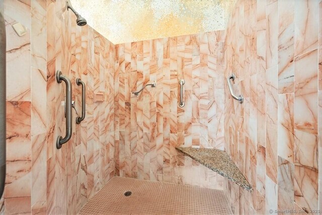 full bath featuring tiled shower